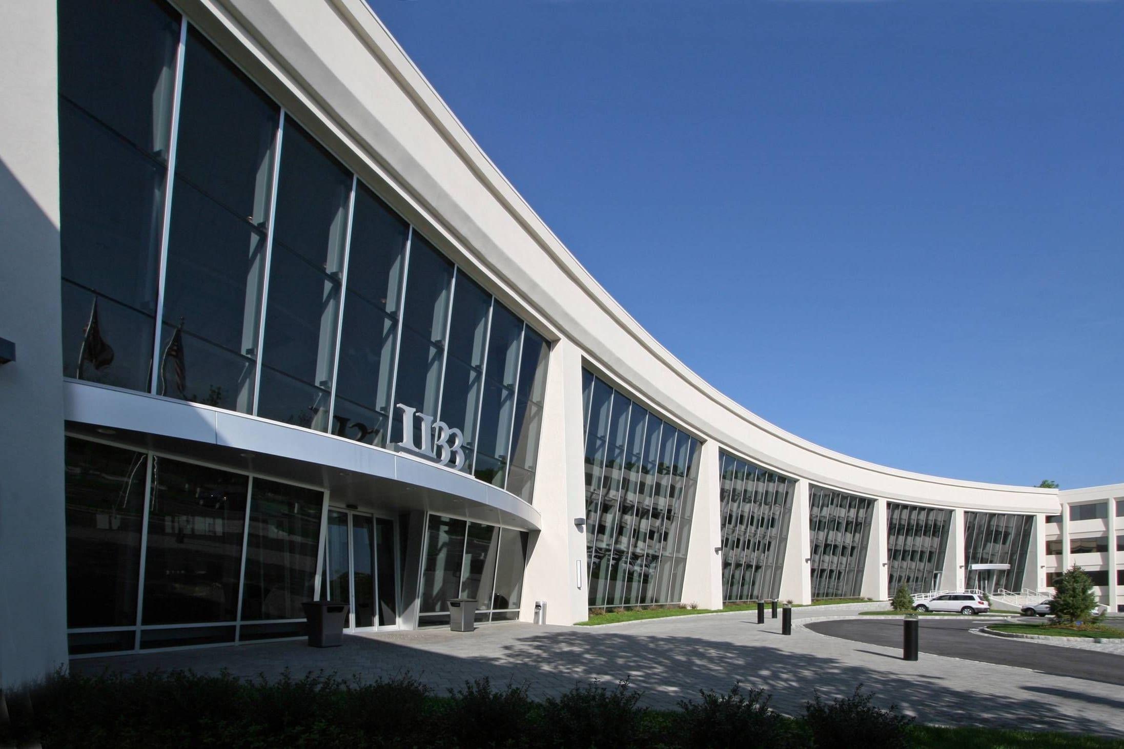 Curved glass facade of the 1133 Westchester Avenue office building